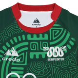 The Las Serpientes Mexico Rugby Replica Jersey by Credo Rugby features a green color, red collar, abstract geometric patterns, "Serpientes" text, twin snake logos, and authentic Credo Rugby branding—designed to honor Mexico’s rugby team.