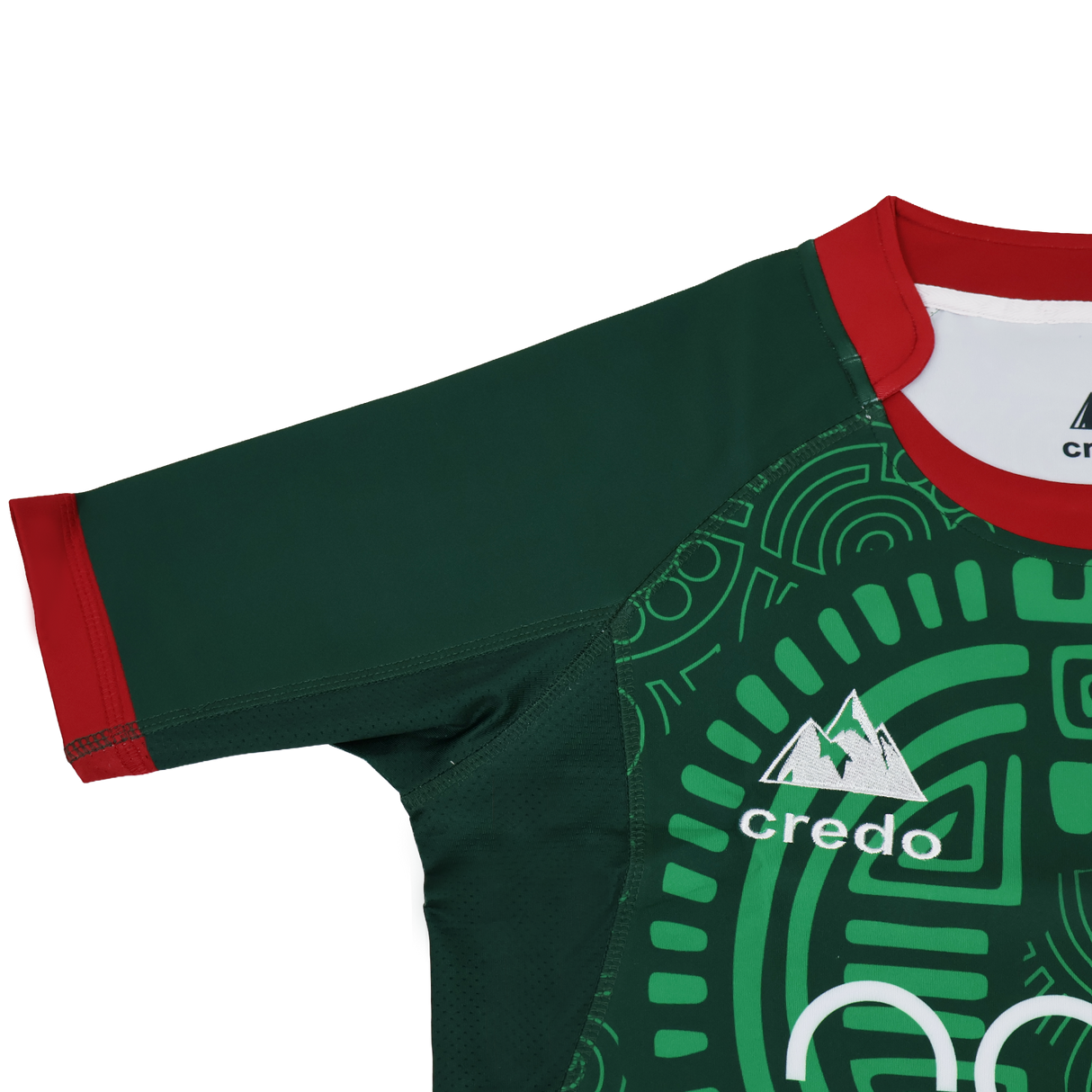 The Las Serpientes Mexico Rugby Replica Jersey by Credo Rugby features a green geometric pattern, red collar and sleeve trim, and the Credo Rugby logo with mountain graphic—boldly inspired by the iconic original jersey.