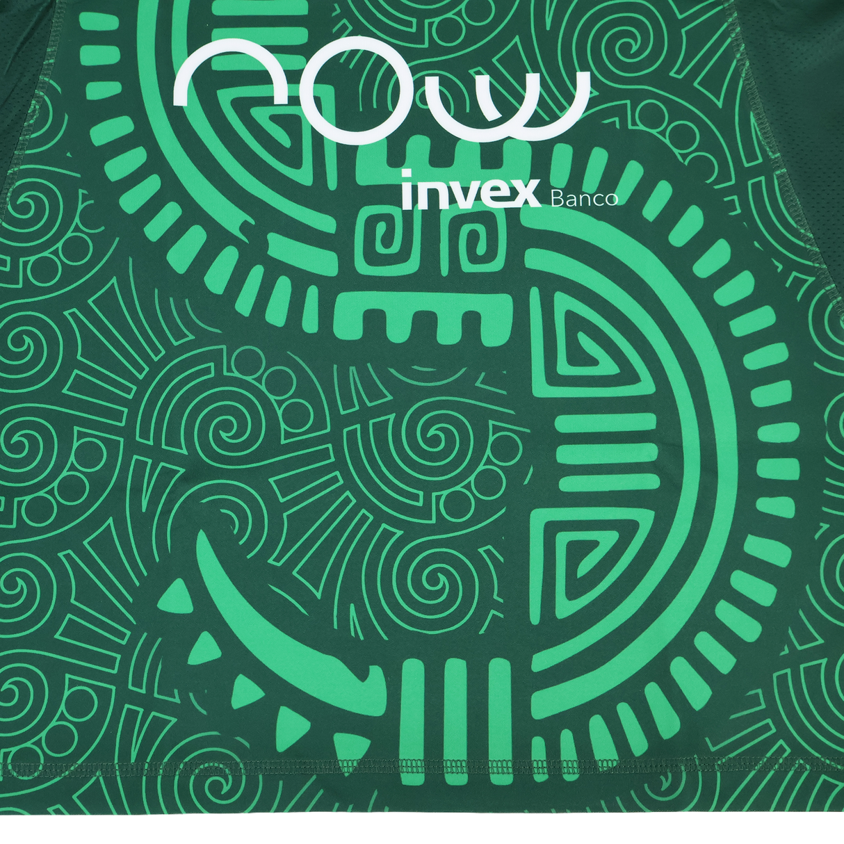 Close-up of the green Las Serpientes Mexico Rugby Replica Jersey by Credo Rugby, featuring a stylized Aztec serpent pattern and white "now invex Banco" text.