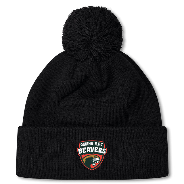 The Omaha Beavers RFC Pom Pom Beanie by EMB Canterbury is a black bobble hat with a pom-pom and features an "Omaha R.F.C. Beavers" logo patch on the front.