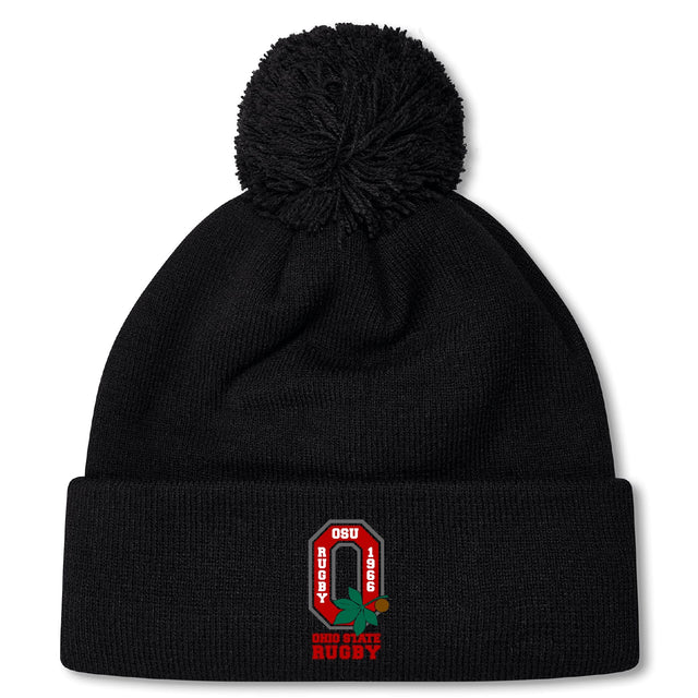 The Ohio State University Alumni Pom Pom Beanie by EMB Canterbury is a black, fleece-lined hat featuring an embroidered red and white "OSU Rugby 1966" logo and "Ohio State Rugby" text on the front, for extra warmth and comfort.