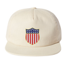 The EMB Weld USA Rugby Original Olympic Brushed Cotton Cap is cream-colored with a front shield emblem featuring the American flag—ideal for supporting USA Rugby or cheering at Olympic events.
