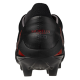 Rear view of a Mizuno Morelia Neo IV FG Made in Japan soccer cleat in black/red, with "MORELIA NEO" on the heel, celebrating Morelia's 40th Anniversary and designed for a barefoot feel on firm ground.