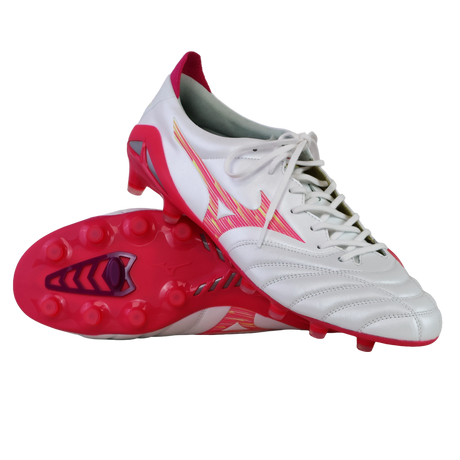 A pair of Mizuno Morelia Neo IV FG soccer cleats in White/Pink Tetra/Fuchsia Purple, featuring premium K-leather, a stylized Mizuno logo, and studded soles—one upright and one lying on its side.