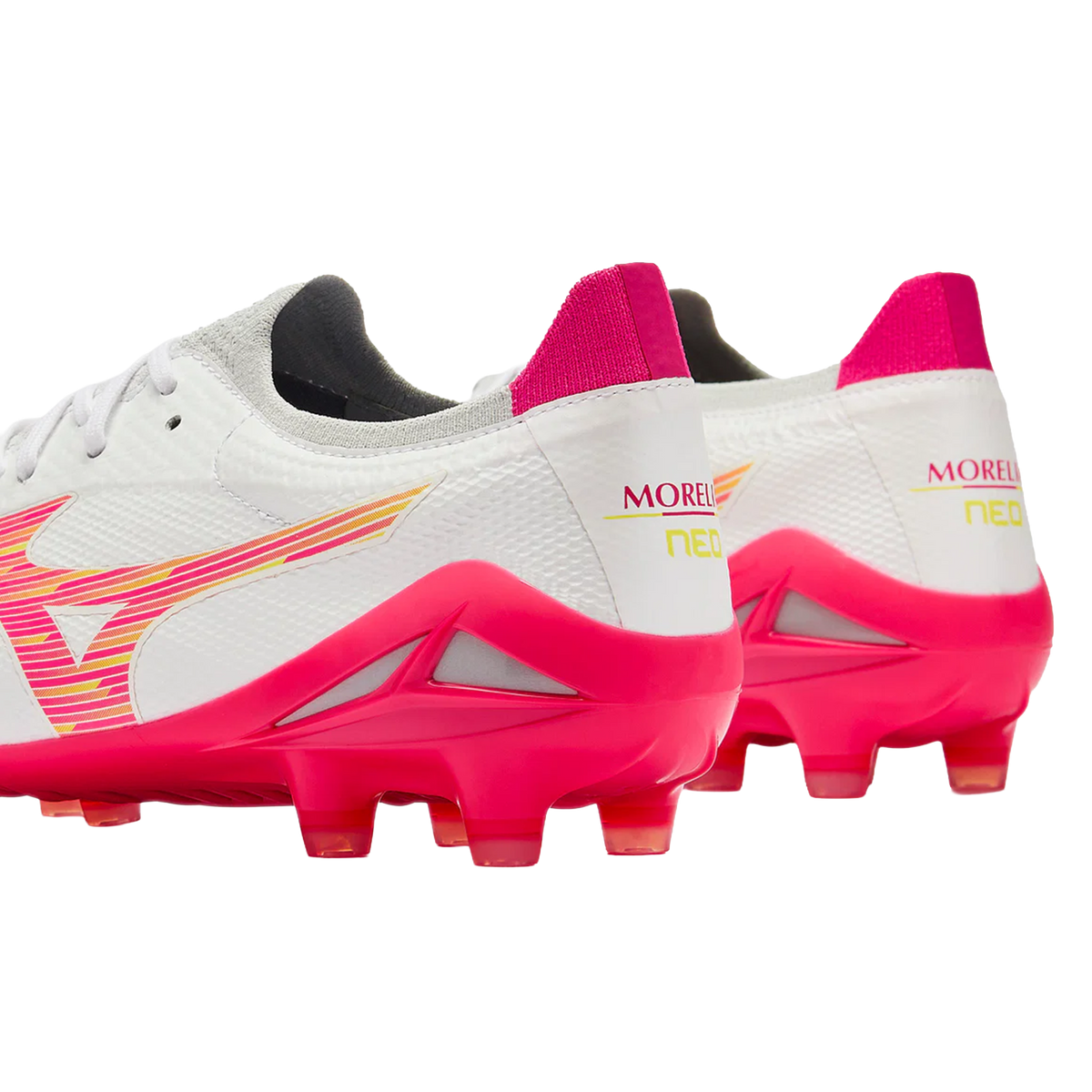 A pair of white and pink Mizuno Morelia Neo IV Beta Elite FG football boots with stud soles, viewed from the rear three-quarter angle.