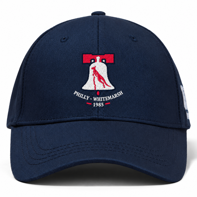 Navy blue Philly Whitemarsh RFC Flexfit Drill Cap by Canterbury featuring an embroidered emblem of a bell containing a kangaroo with the text “Philly - Whitemarsh 1985” underneath.
