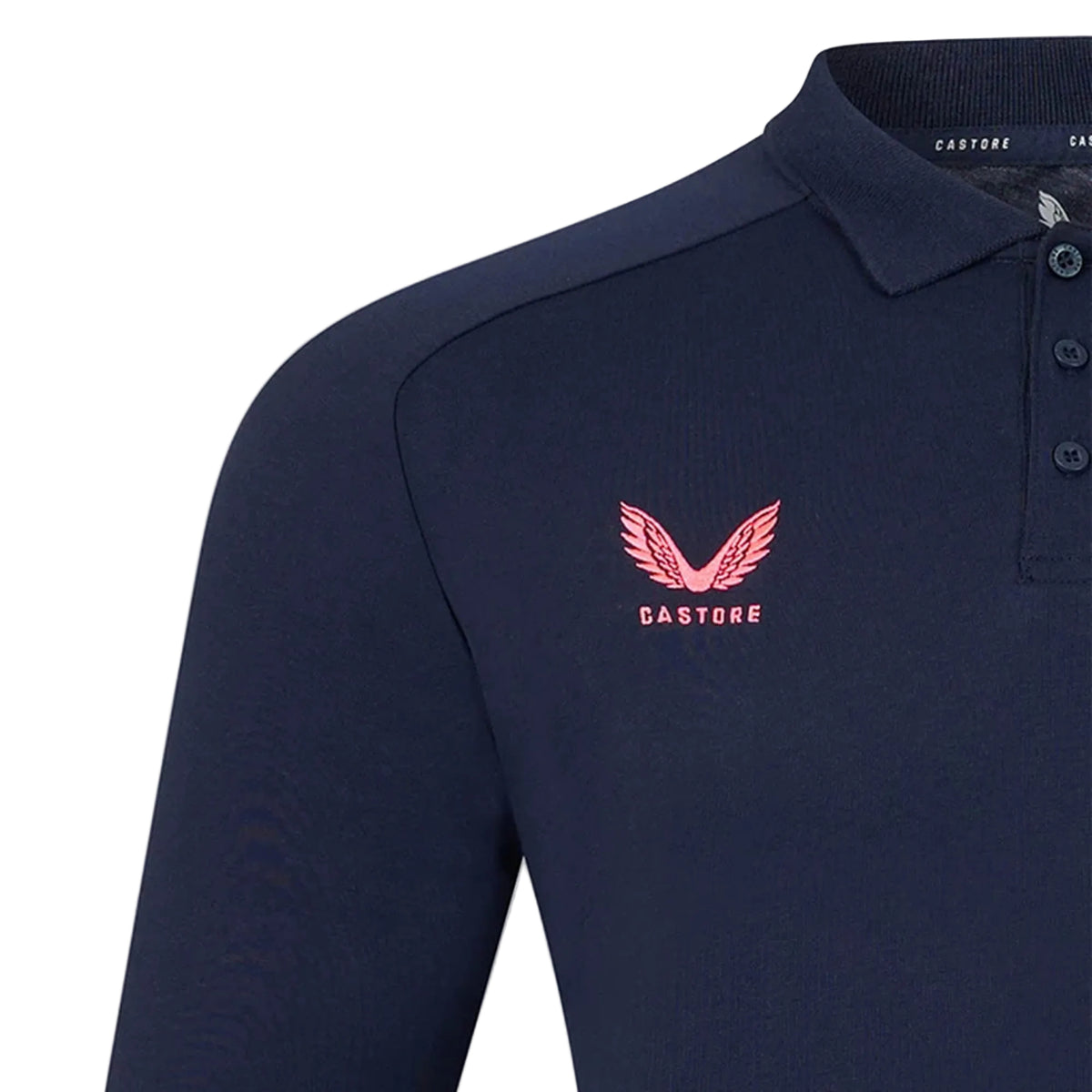 The Harlequins 26/27 Off Pitch Polo by Castore is a navy blue long-sleeve polo shirt featuring a pink Castore logo and text on the left chest, plus a button placket at the collar—an ideal choice for fans looking for the Mens 2026/27 Polo or Harlequins Travel Polo style.