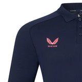 The Harlequins 26/27 Off Pitch Polo by Castore is a navy blue long-sleeve polo shirt featuring a pink Castore logo and text on the left chest, plus a button placket at the collar—an ideal choice for fans looking for the Mens 2026/27 Polo or Harlequins Travel Polo style.