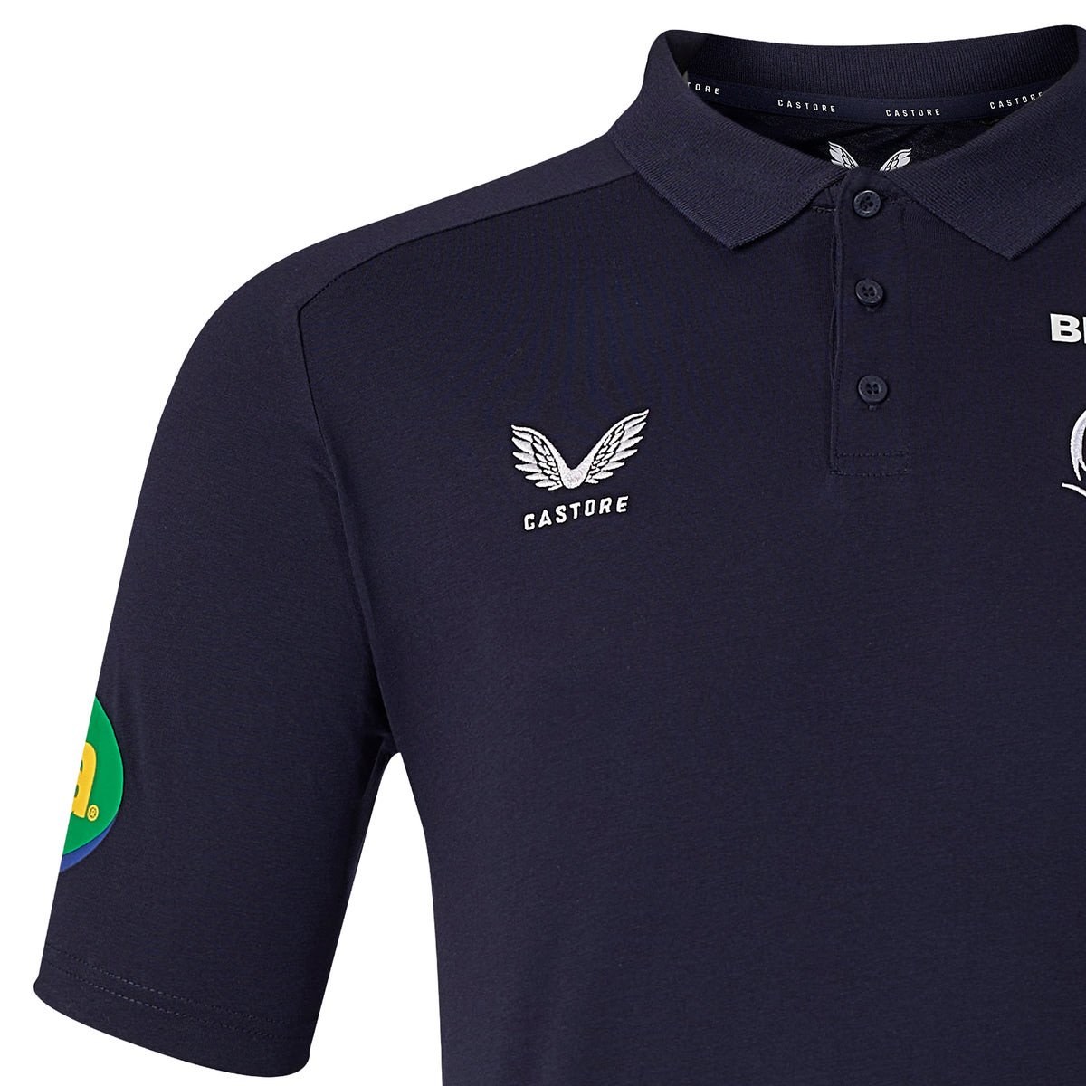 Leicester 26/27 Off Pitch Polo by Castore in navy blue, featuring the signature Castore logo on the chest, a button placket, and a distinctive green-yellow patch on the left sleeve—offering a stylish take inspired by the iconic Leicester Tigers polo design.