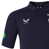 Leicester 26/27 Off Pitch Polo by Castore in navy blue, featuring the signature Castore logo on the chest, a button placket, and a distinctive green-yellow patch on the left sleeve—offering a stylish take inspired by the iconic Leicester Tigers polo design.