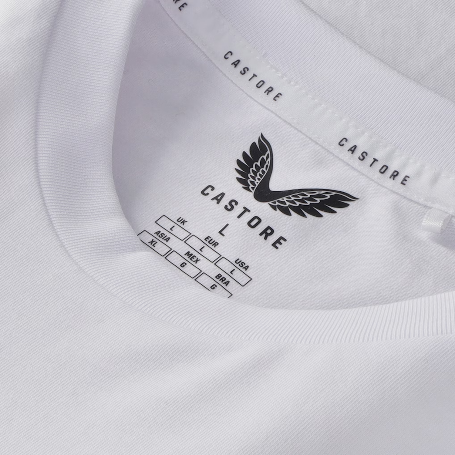 Close-up of the England 26/27 Off-Pitch Tee by Castore, featuring the brand logo and size label printed inside the neckline.