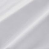 Close-up of plain white fabric with diagonal weave and soft lighting, highlighting its texture—perfect for the England 26/27 Off-Pitch Tee by Castore.