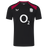 The England 26/27 Performance Training Tee by Castore features black short sleeves, red shoulder panels, a white "O2" sponsor logo, the rugby rose emblem, Castore branding, and moisture-wicking tech for comfort.