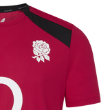 A close-up of the England 26/27 Performance Training Tee by Castore, a red jersey with a white rose emblem on the chest, black shoulder accents, and advanced moisture-wicking technology.