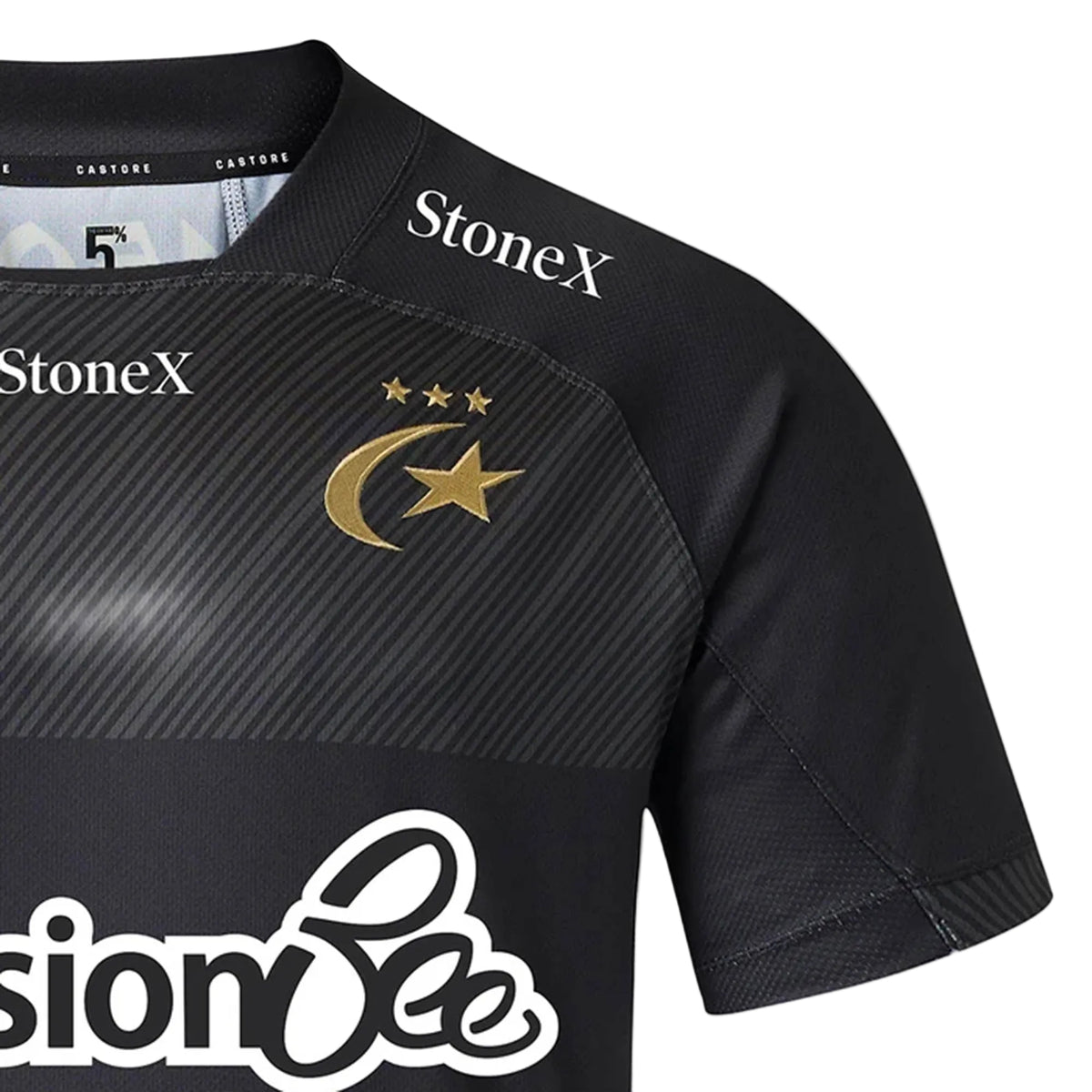 Here’s a rewritten version of the sentence, incorporating the provided product data: Close-up of the Saracens 26/27 Replica Home Jersey by Castore—a black shirt with bold gold accents, adorned with three stars and a crescent with a star, and displaying white “StoneX” and Castore sponsor logos.