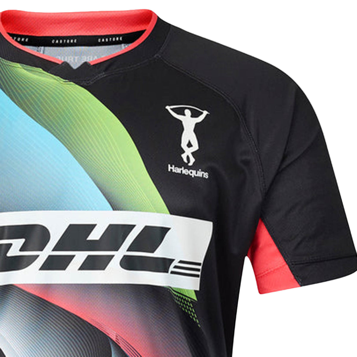 The Harlequins 26/27 Replica Third Jersey by Castore features a black design with vibrant colorful accents, the DHL sponsor logo, and the iconic Harlequins Rugby Club emblem with an acrobat silhouette on the upper left chest. Designed for dedicated fans, this Castore jersey captures the dynamic spirit of the Big Game 18 Shirt, making a bold statement both on and off the pitch.