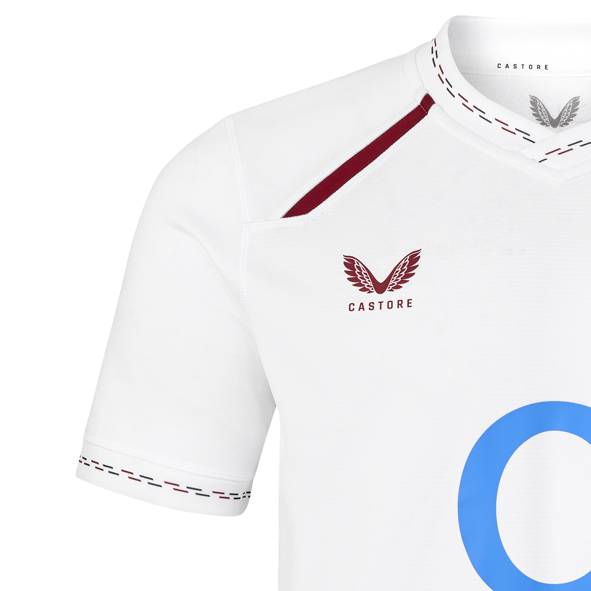 The England 26/27 Replica Home Jersey by Castore features a white design with maroon trim, the signature Castore logo on the chest, and part of a bold blue “O” on the front—making it the perfect choice for dedicated England Rugby fans seeking an authentic replica home jersey.