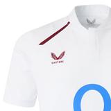 Close-up of the England 26/27 Classic Home Jersey by Castore, featuring a maroon winged logo, "Castore" text on the chest, blue "O" detailing, and a buttoned collar for a fresh update on the iconic look.