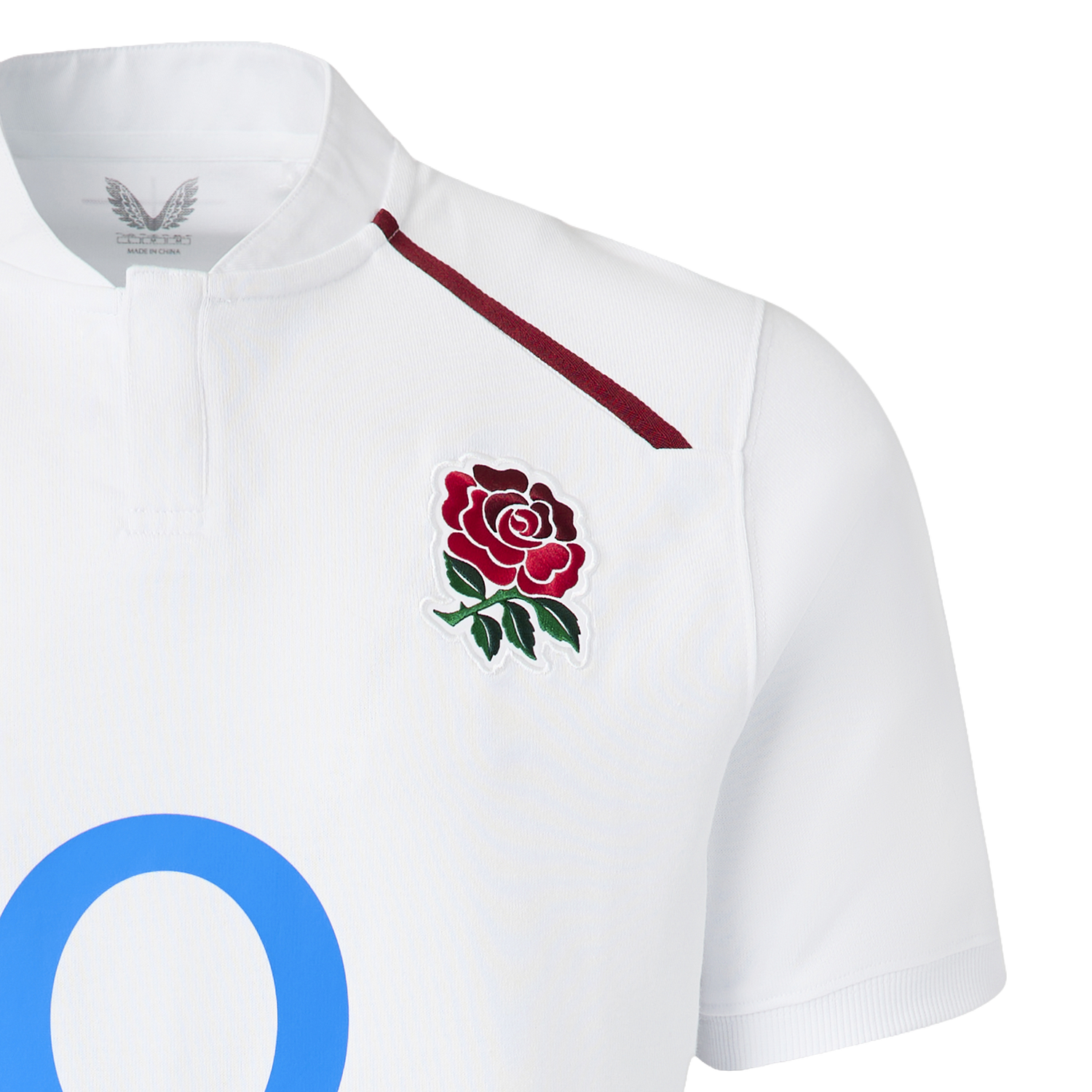 The England 26/27 Classic Home Jersey by Castore features a white design with a maroon rose emblem, thin maroon shoulder stripe, and a large blue "O"—a must-have for rugby fans.