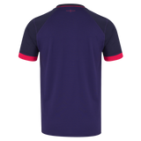 The image displays the back of the England 26/27 Replica Alternate Jersey by Castore, a short-sleeved shirt in dark purple with contrasting red sleeve cuffs and a small pink cross detail near the collar, highlighting the vibrant design elements characteristic of this alternate kit from Castore.