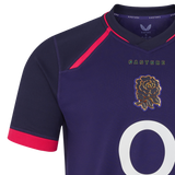 The England 26/27 Replica Alternate Jersey by Castore showcases a rich dark purple design with bold red trim, highlighted by the Castore logo, the iconic rose emblem, and a prominent white number on the front—a striking Rhodonite kit ideal for passionate supporters.