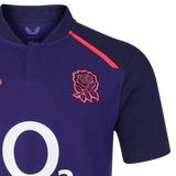 A close-up of the England 26/27 Classic Alternate Jersey by Castore in navy, showcasing the red rose emblem, red shoulder stripes, and a partial white "O2" logo—iconic elements from the Castore brand.