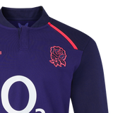 A close-up of the England 26/27 Classic Long Sleeve Alternate Jersey by Castore—a dark blue rugby top with a red rose emblem on the chest and a white "O2" logo below.