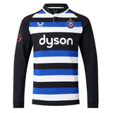 The Bath 26/27 Classic Long Sleeve Home Jersey by Castore features black, blue, and white horizontal stripes, a “dyson” sponsor logo, star and crest on the chest, and black sleeves—a timeless heritage rugby shirt from Castore.