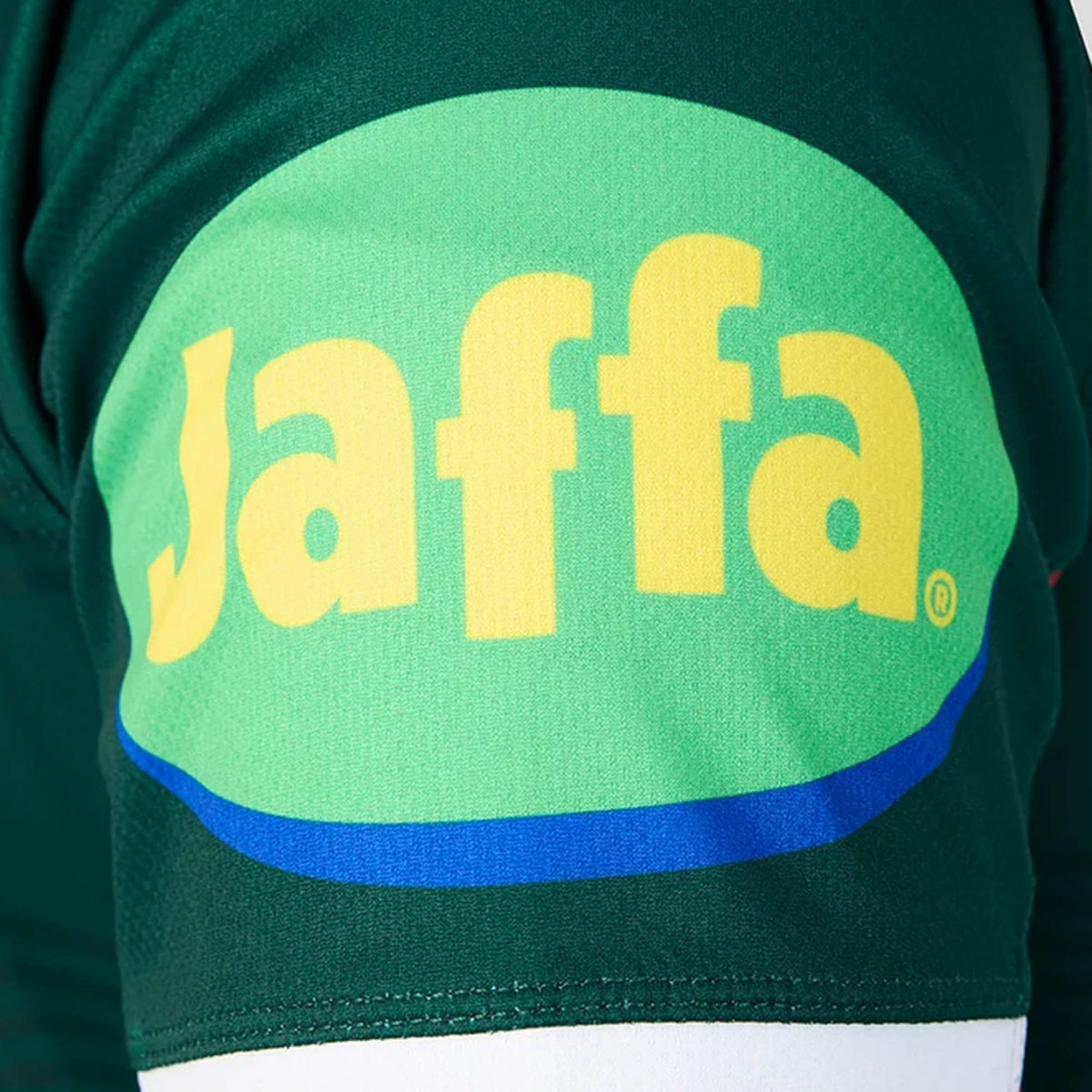 Close-up of a green sleeve from the Leicester 26/27 Replica Home Jersey by Castore, featuring a large yellow “Jaffa” logo printed on an oval green and blue background.