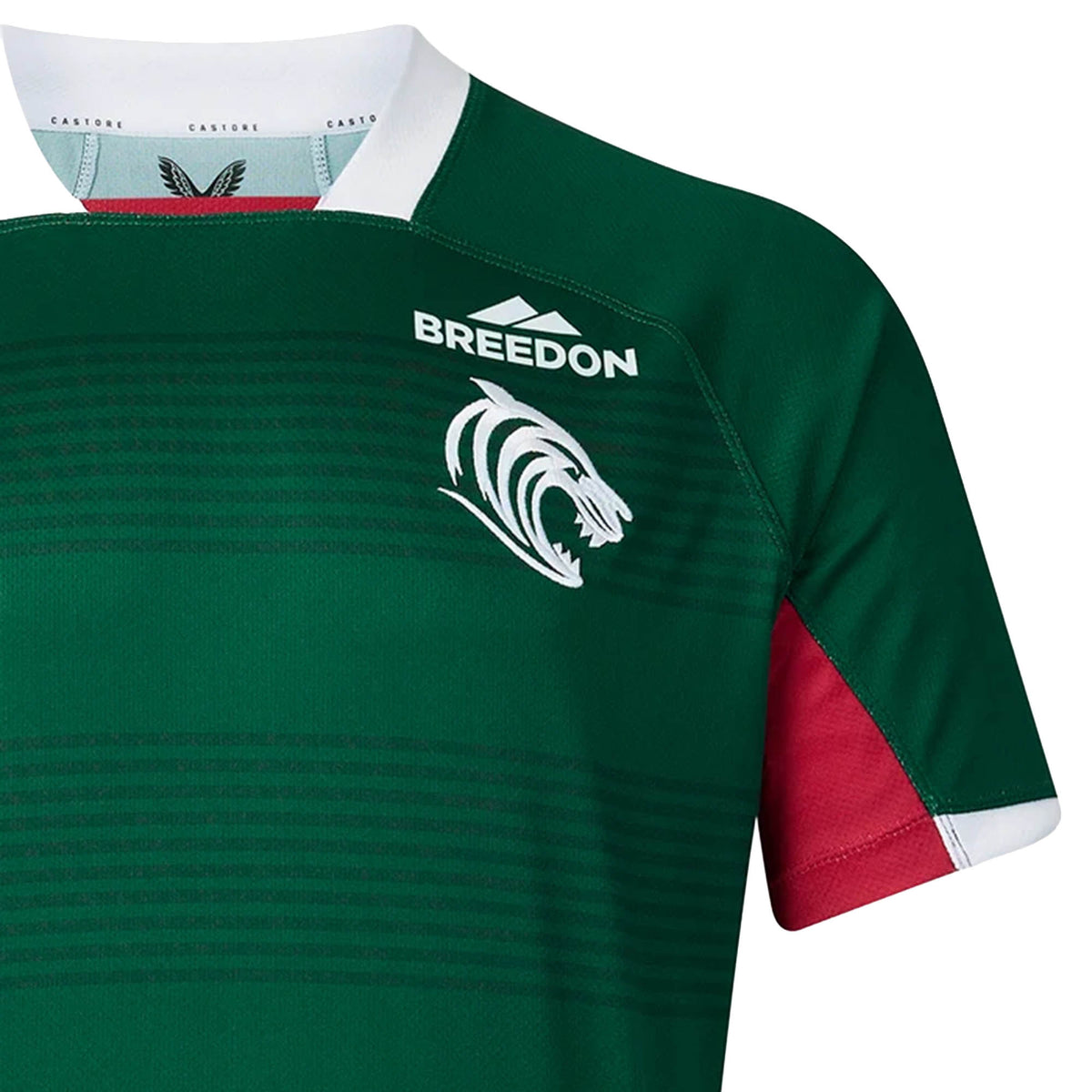 The Leicester 26/27 Replica Home Jersey by Castore features a green and red design with a white roaring lion logo, “Breedon” sponsor text, and a white collar, authentically styled as the team’s home jersey.