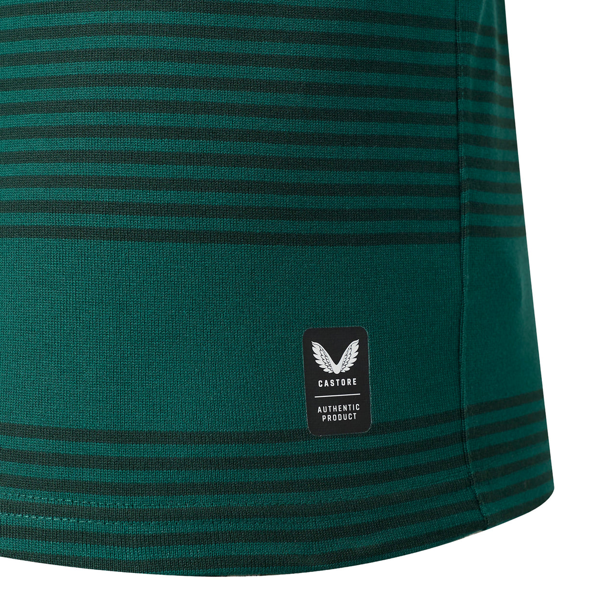 Close-up of the green and black striped fabric from the Leicester 26/27 Classic Long Sleeve Home Jersey by Castore, featuring a rectangular Castore Authentic Product label near the hem.
