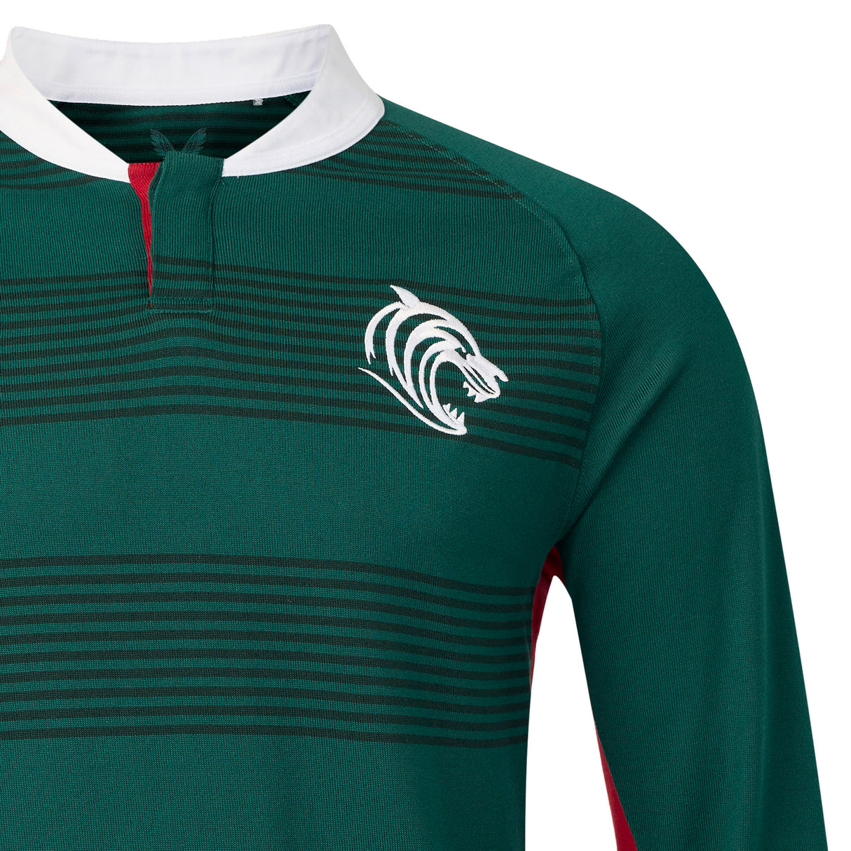 The Leicester 26/27 Classic Long Sleeve Home Jersey by Castore features green and black stripes, long sleeves, a white collar, and a stylized white tiger logo on the left chest. Taking inspiration from the classic Leicester Tigers jersey, this Castore design is enhanced with red detailing near the collar and along the sides for a bold, sporty appearance.