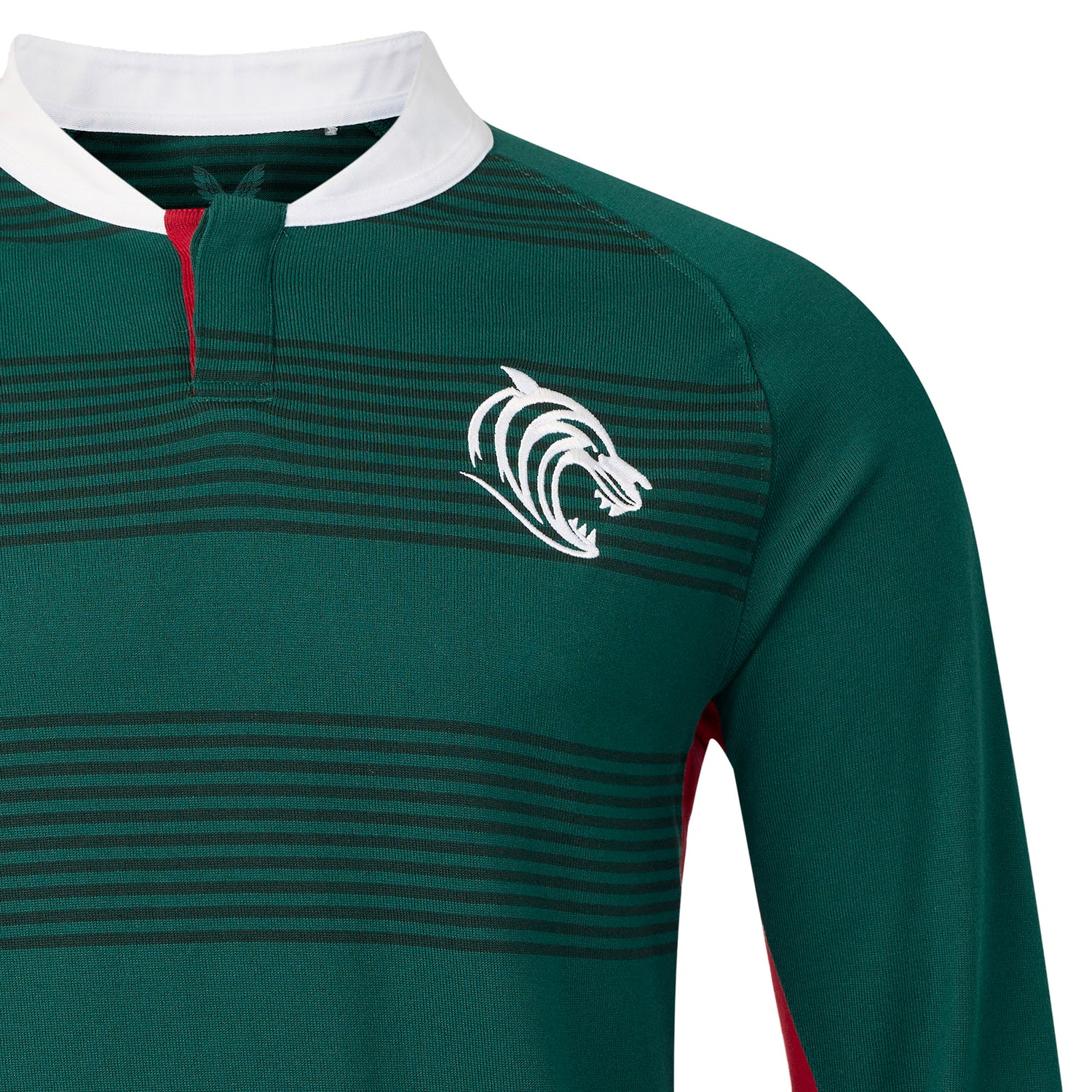 The Leicester 26/27 Classic Long Sleeve Home Jersey by Castore features green and black stripes, long sleeves, a white collar, and a stylized white tiger logo on the left chest. Taking inspiration from the classic Leicester Tigers jersey, this Castore design is enhanced with red detailing near the collar and along the sides for a bold, sporty appearance.