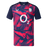 The England 26/27 Pre-Match Top by Castore is a short-sleeved shirt with a navy and bright pink geometric pattern, featuring the O2 logo and a white rose emblem on the chest.