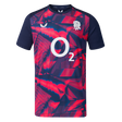 The England 26/27 Pre-Match Top by Castore is a short-sleeved shirt with a navy and bright pink geometric pattern, featuring the O2 logo and a white rose emblem on the chest.