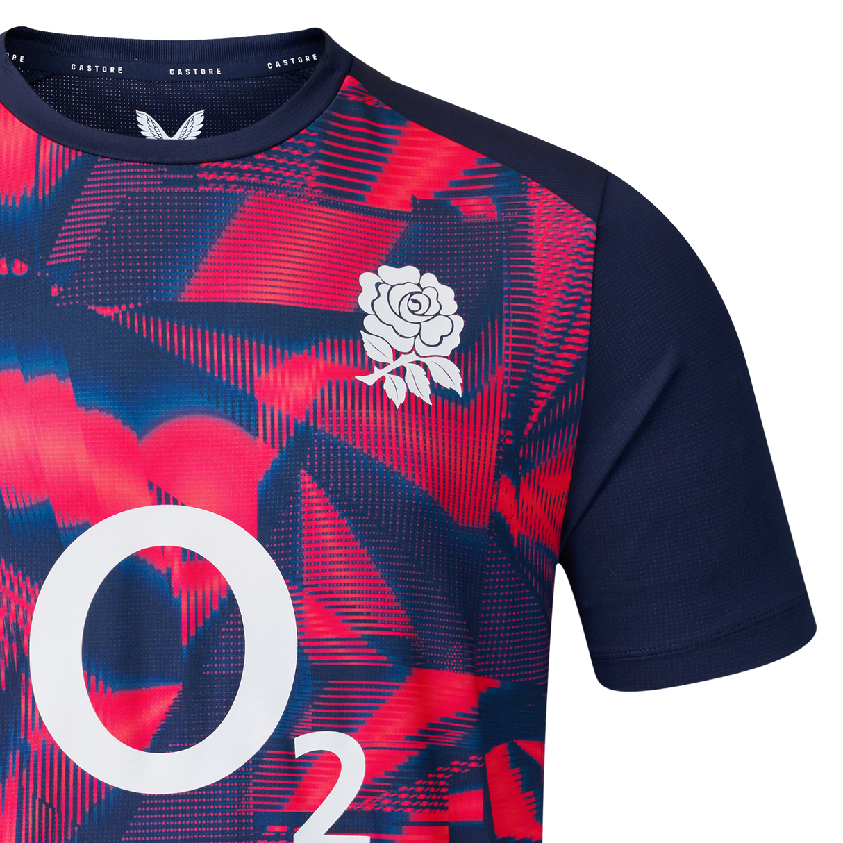 Close-up of the England 26/27 Pre-Match Top by Castore, displaying a red and blue geometric pattern, white rose chest emblem, and O2 branding.