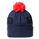 The England 26/27 Bobble Beanie by Castore is a navy blue knit hat featuring bold black lettering, a folded brim with a small Castore logo, and topped with a bright red pom-pom—making it the perfect winter accessory for any England supporter.