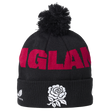 The England 26/27 Bobble Beanie by Castore is a black knit beanie featuring a pom-pom, bold red “ENGLAND” lettering, and a white rose emblem on the fold—an essential winter accessory for England supporters and the perfect Castore beanie for chilly rugby match days.