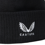 Close-up of the England 26/27 Bobble Beanie by Castore, a black knit beanie featuring a white winged embroidered Castore logo above the front text. This stylish winter accessory is perfect for England rugby supporters.