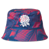 The Castore England 26/27 Reversible Bucket Cap features blue and red patterns and a white embroidered rose on the front, taking inspiration from the iconic England rugby cap.