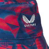 Close-up of the England 26/27 Reversible Bucket Cap by Castore, showcasing a blue and red patterned fabric with a white embroidered Castore wings logo. This lightweight bucket hat offers sun protection for outdoor activities and combines stylish design with practical comfort.