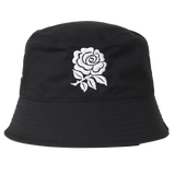 The England 26/27 Reversible Bucket Cap by Castore features a black design with a white rose embroidered on the front, providing lightweight sun protection—ideal for fans of Castore England rugby or anyone looking for a stylish, classic England reversible bucket cap.
