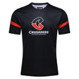 This Crusaders Super Rugby Supporters Tee 24 by Classic Sportswear features a black short-sleeve jersey with red accents, showcasing the "Crusaders" logo and the text "Ma Pango Ma Whero" on the front. Crafted from breathable fabric for ultimate comfort, it boasts a black base perfect for all fans.