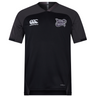 The Valley Panthers Girls Rugby Vapodri Evader Jersey by EMB Canterbury is a black, short-sleeved performance rugby shirt featuring the Valley Panthers Girls Rugby logo on the chest, a Canterbury brand logo, and subtle dark gray shoulder panels. Designed with moisture-wicking Vapodri technology for high performance both on and off the field.