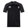 A black Superior Rugby Club Vapodri Evader Jersey by EMB Canterbury, featuring short sleeves and "Canterbury" plus "Salford Red Devils" logos on the chest. Made with moisture-wicking Vapodri tech, shown on a plain white background.