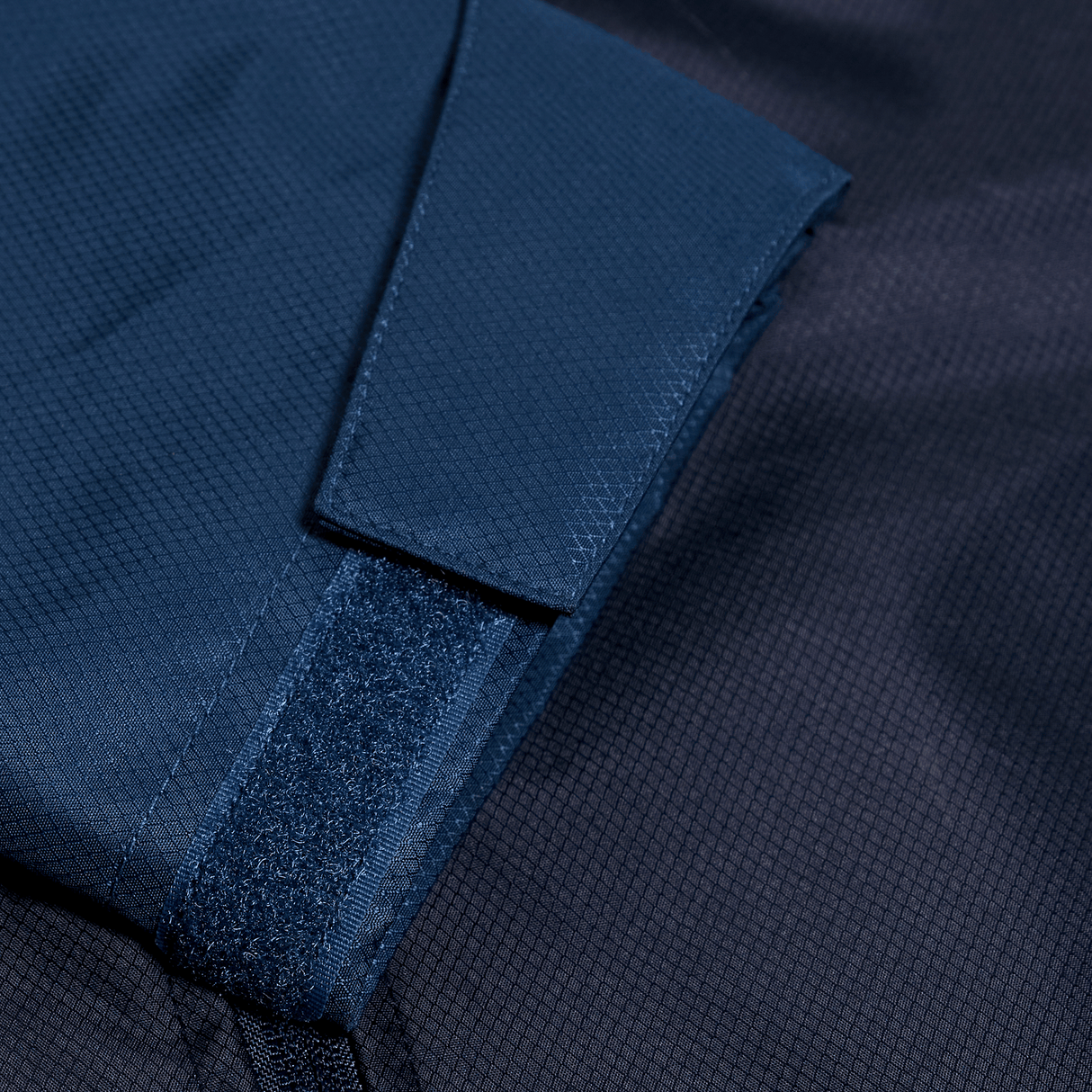 A close up view of a Canterbury Pro II Vaposhield Full-Zip Water Resistant Jacket in blue.