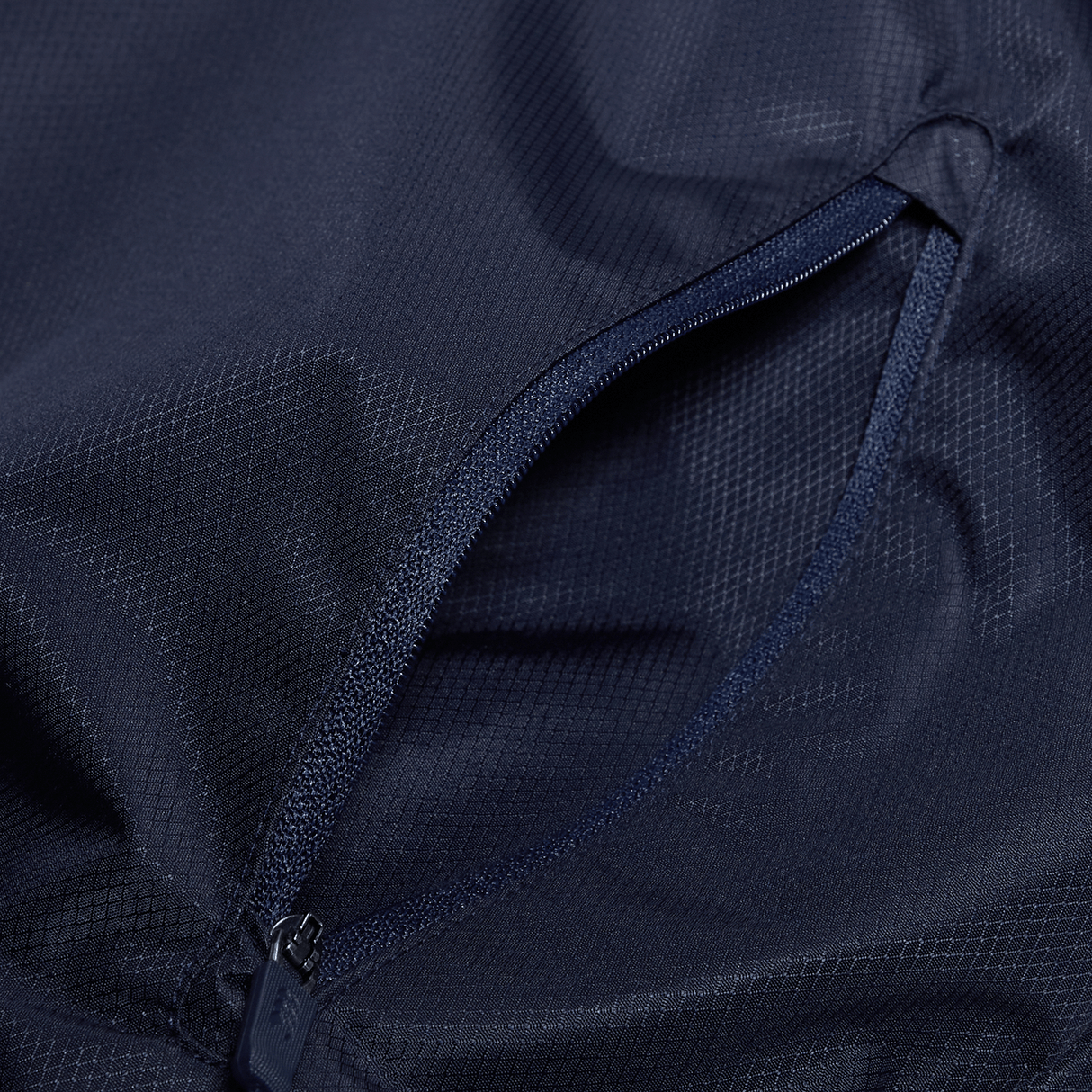 a close up of the zipper of a Canterbury Pro II Vaposhield Full-Zip Water Resistant Jacket by Canterbury.