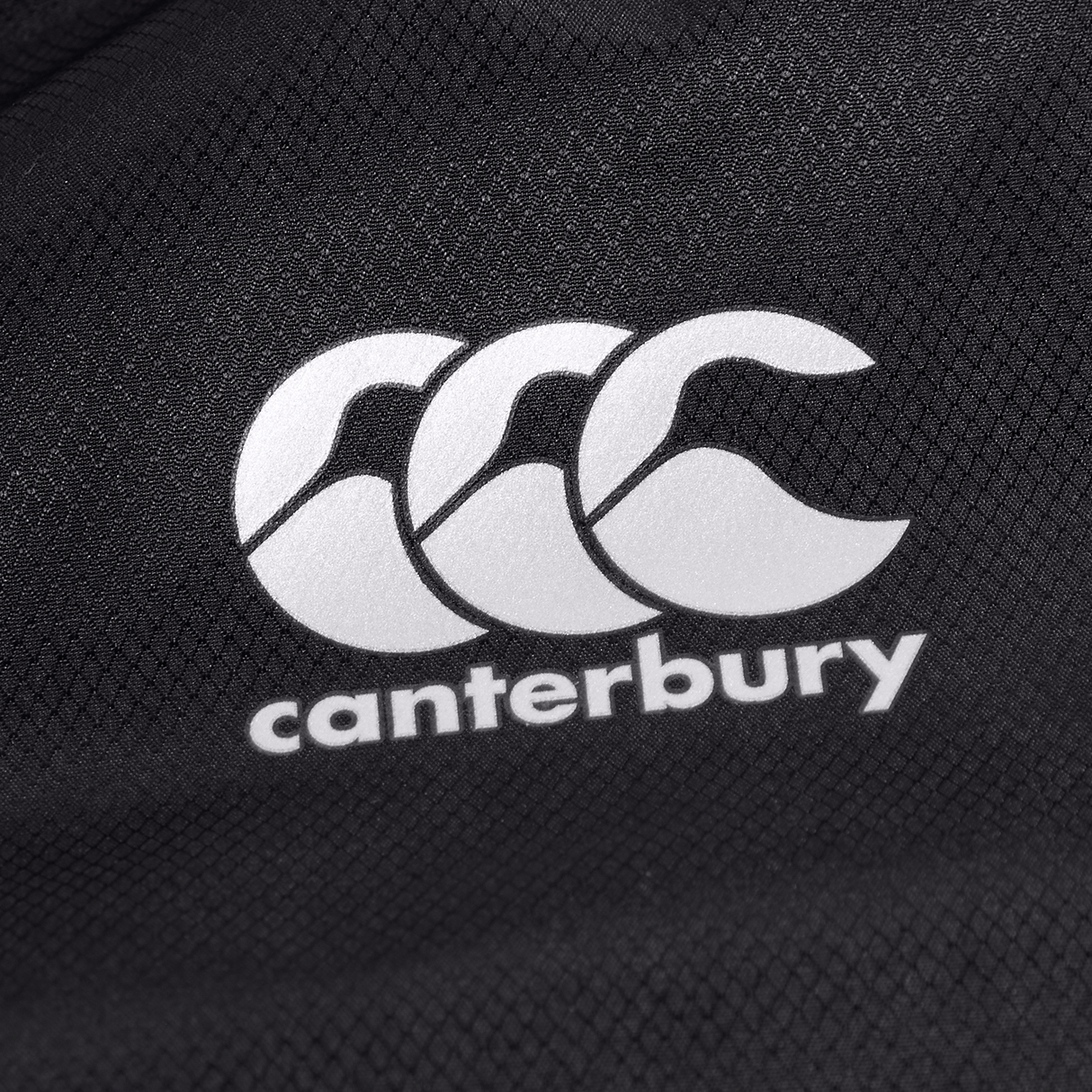 A Canterbury logo on a black Canterbury Pro II Vaposhield Full-Zip Water Resistant Jacket.