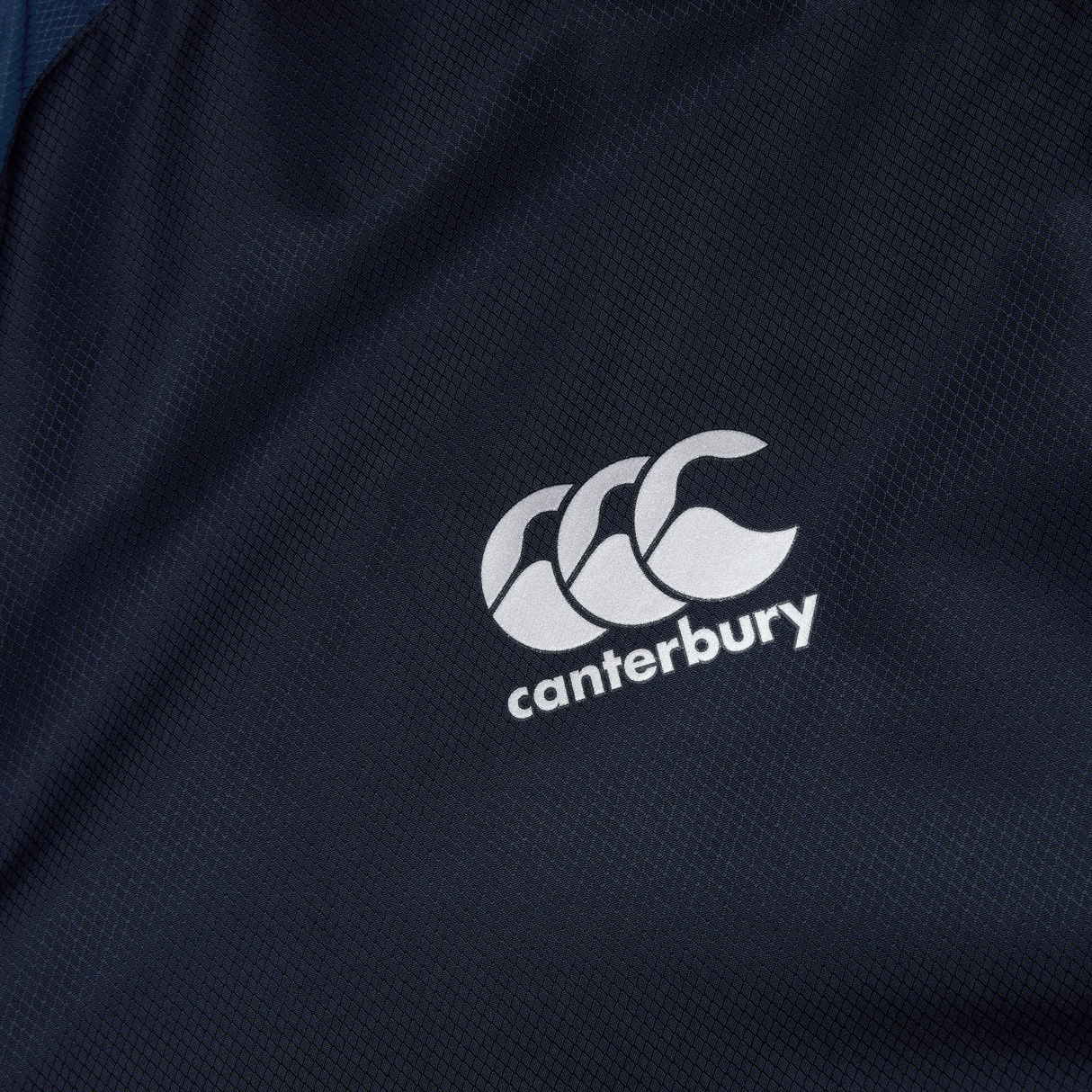 A close up of a Canterbury logo on a Canterbury Pro II Vaposhield Full-Zip Water Resistant Jacket.