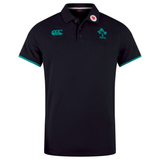 The Ireland 24 Team Polo by Canterbury is a black cotton polo with green accents, featuring a ribbed collar and cuffs, classic clover emblem, "IRFU" text, and embroidered chest logos.